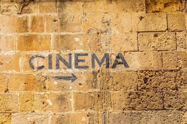 Italy-Basilicata-Province of Matera-Matera Sign on a wall pointing to a cinema-movie theater